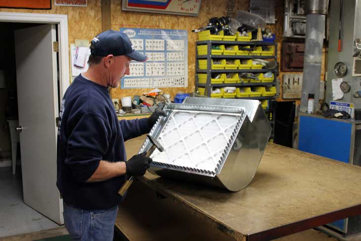 Photo of service technician doing fabrication work.